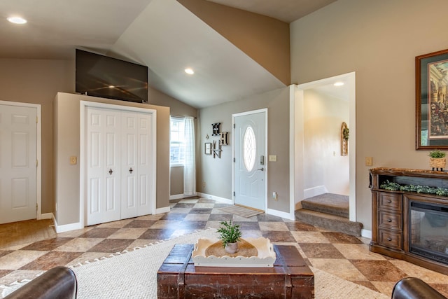 8510 Clarkson Rd, Rapid City, SD 57702 - foyer with lofted ceiling, a glass covered fireplace, baseboards, and recessed lighting