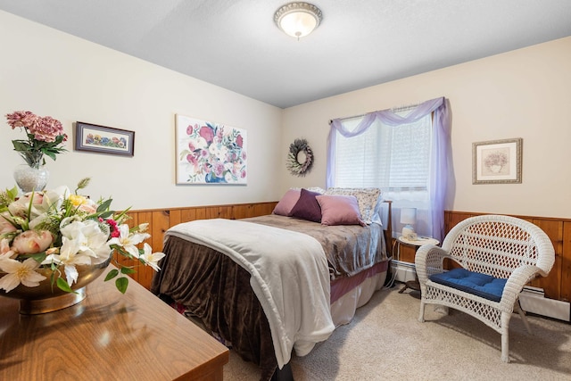 22994 Shields Rd, Rapid City, SD 57702 - bedroom featuring a wainscoted wall, wood walls, and light carpet