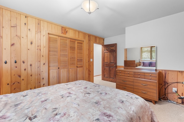 22994 Shields Rd, Rapid City, SD 57702 - bedroom with wooden walls, light carpet, and a closet