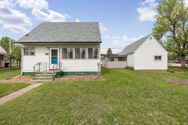 2101 Juniper Dr, Rapid City, SD 57702 - back of property featuring roof with shingles and a yard