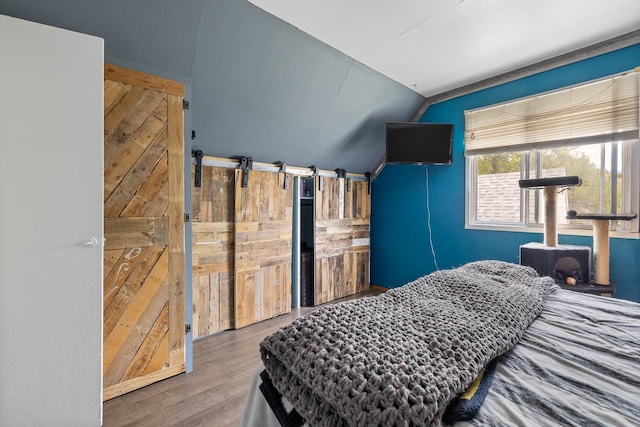 2101 Juniper Dr, Rapid City, SD 57702 - bedroom featuring vaulted ceiling and wood finished floors