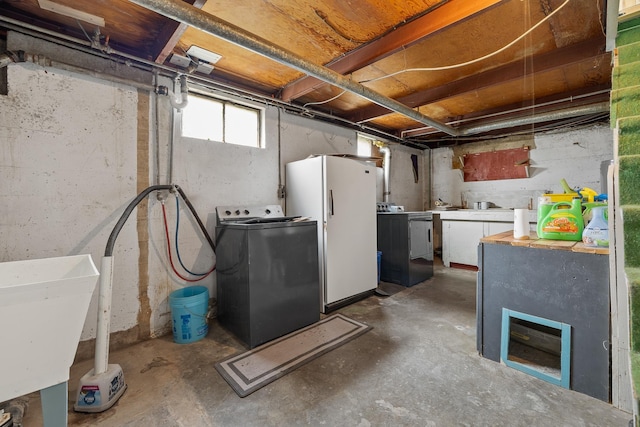 2101 Juniper Dr, Rapid City, SD 57702 - basement featuring washer / dryer, freestanding refrigerator, and a sink