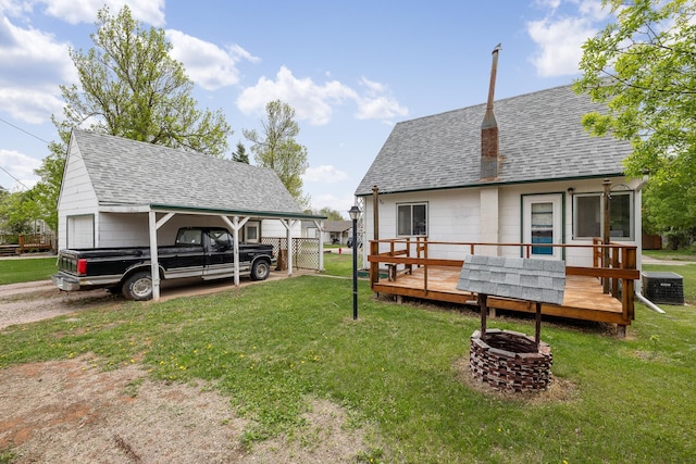 2101 Juniper Dr, Rapid City, SD 57702 - view of grassy yard with an outdoor fire pit, a wooden deck, and cooling unit