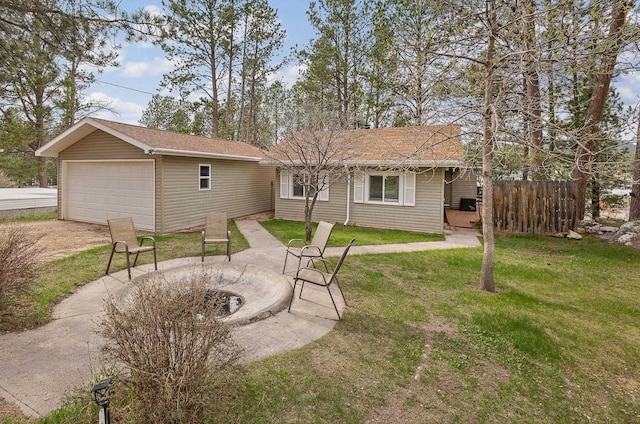 123 Gordon St, Custer, SD 57730 - rear view of property with a detached garage, an outbuilding, a fire pit, and a patio
