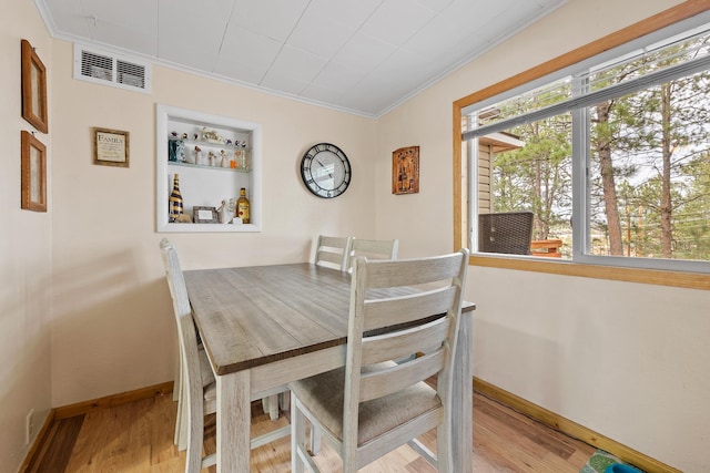 123 Gordon St, Custer, SD 57730 - dining area featuring crown molding, baseboards, and wood finished floors