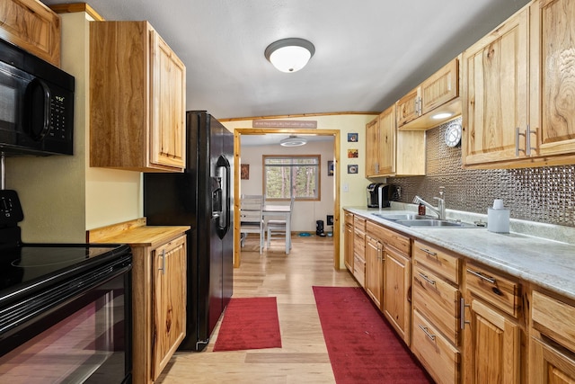 123 Gordon St, Custer, SD 57730 - kitchen featuring black appliances, light countertops, light wood-style flooring, and a sink