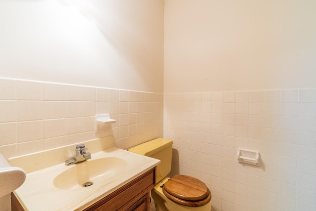 15630 Antelope Creek Rd, Rapid City, SD 57703 - half bath featuring tile walls, vanity, toilet, and wainscoting