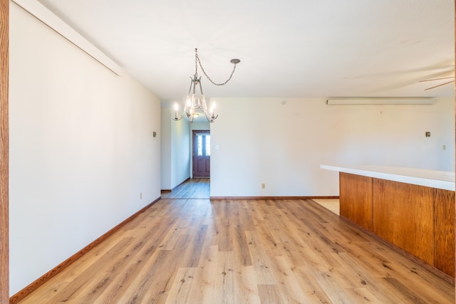 15630 Antelope Creek Rd, Rapid City, SD 57703 - unfurnished dining area with a chandelier, light wood-style floors, and baseboards