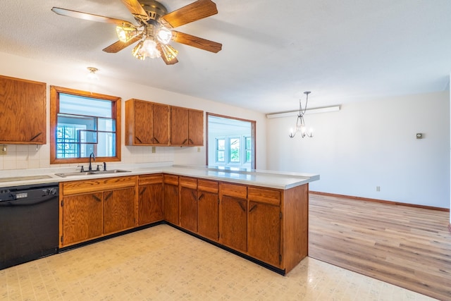 15630 Antelope Creek Rd, Rapid City, SD 57703 - kitchen with dishwasher, a sink, brown cabinets, light countertops, and a peninsula