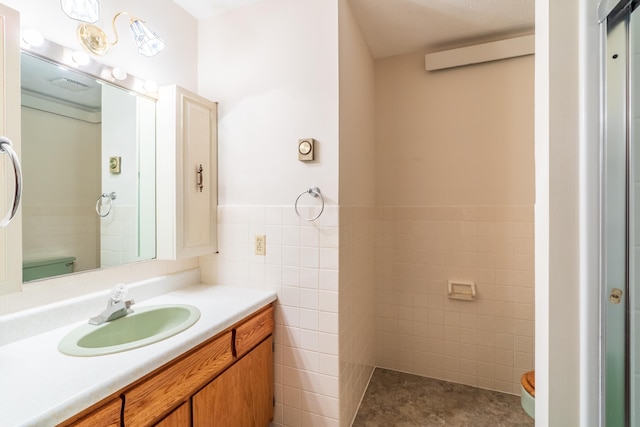 15630 Antelope Creek Rd, Rapid City, SD 57703 - bathroom featuring tile walls, vanity, wainscoting, and tile patterned flooring
