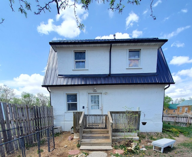 400 5th Ave, Edgemont, SD 57735 - back of property featuring stucco siding, metal roof, and fence