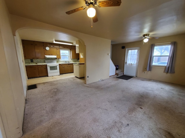 400 5th Ave, Edgemont, SD 57735 - unfurnished living room with arched walkways, ceiling fan, stairway, and light colored carpet