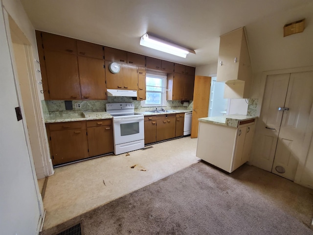400 5th Ave, Edgemont, SD 57735 - kitchen featuring white appliances, a sink, under cabinet range hood, and light countertops
