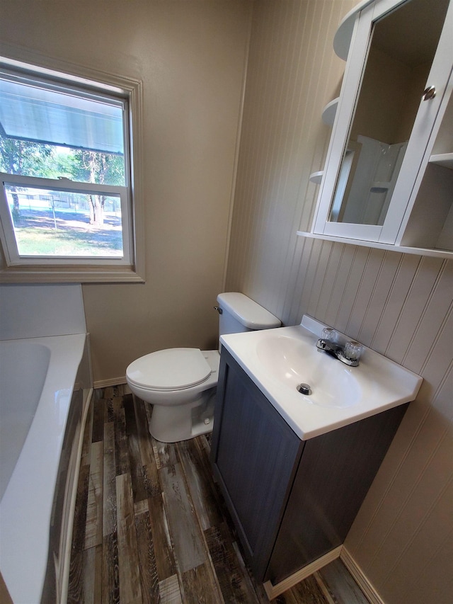 105 N Washington St, Edgemont, SD 57735 - bathroom featuring wood finished floors, toilet, vanity, a tub, and wood walls