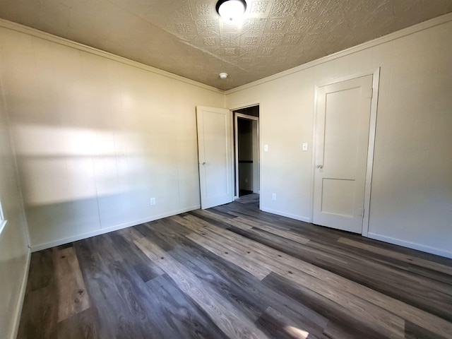 105 N Washington St, Edgemont, SD 57735 - unfurnished bedroom with dark wood-style flooring, ornamental molding, baseboards, and an ornate ceiling