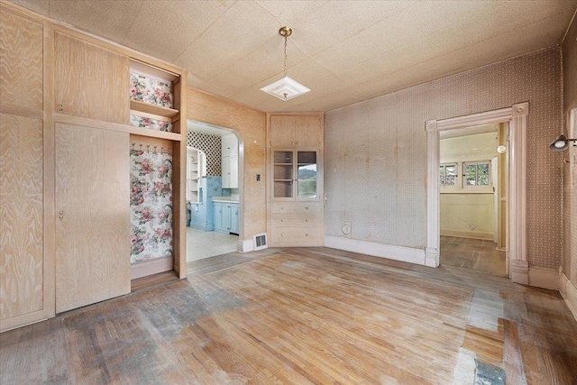 308 Main St, Deadwood, SD 57732 - unfurnished dining area featuring light wood-style floors and arched walkways