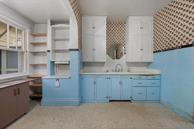 308 Main St, Deadwood, SD 57732 - kitchen with a sink, blue cabinets, open shelves, white cabinets, and light countertops