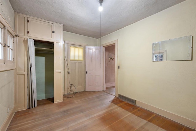 308 Main St, Deadwood, SD 57732 - unfurnished room with baseboards, light wood finished floors, and a textured ceiling