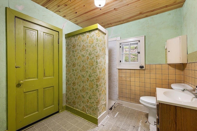 308 Main St, Deadwood, SD 57732 - full bathroom featuring wooden ceiling, a stall shower, toilet, tile patterned flooring, and vanity