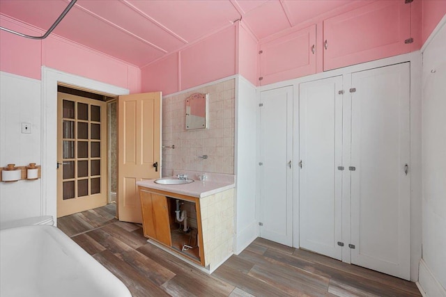308 Main St, Deadwood, SD 57732 - full bath featuring wood finished floors, a tub, and vanity