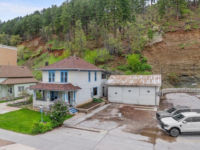 308 Main St, Deadwood, SD 57732 - view of front of house featuring a porch and an outbuilding