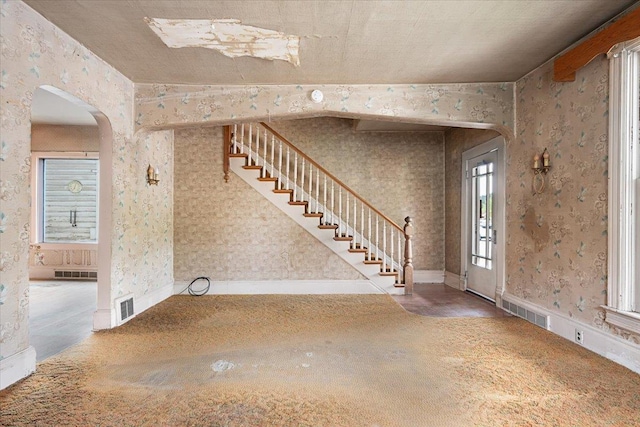308 Main St, Deadwood, SD 57732 - entryway with arched walkways, stairs, and wallpapered walls