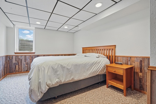 18977 Black Angus Ln, Belle Fourche, SD 57717 - bedroom with wooden walls, carpet flooring, wainscoting, and recessed lighting