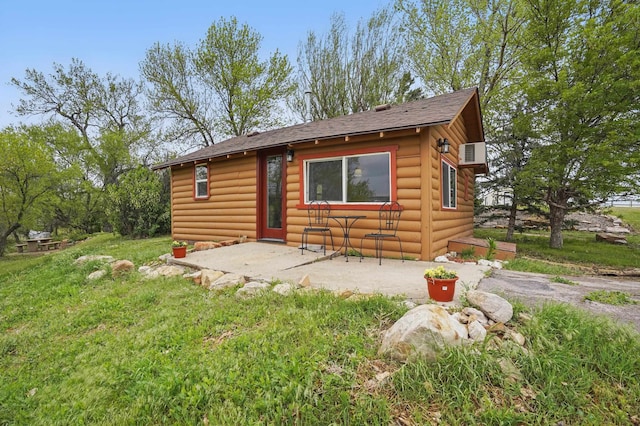 18977 Black Angus Ln, Belle Fourche, SD 57717 - rustic home featuring a patio, log veneer siding, and roof with shingles
