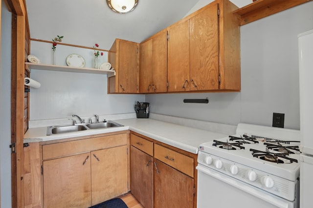 18977 Black Angus Ln, Belle Fourche, SD 57717 - kitchen featuring white gas range oven, open shelves, a sink, and light countertops