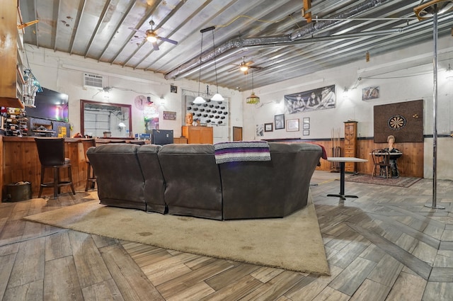 18977 Black Angus Ln, Belle Fourche, SD 57717 - living room with wood finished floors, a dry bar, wood walls, and a wainscoted wall