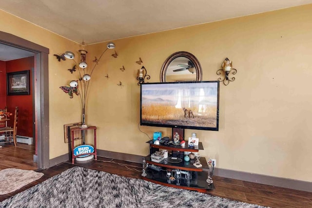 1007 Elkhorn St, Belle Fourche, SD 57717 - living area with wood finished floors, a baseboard radiator, and baseboards