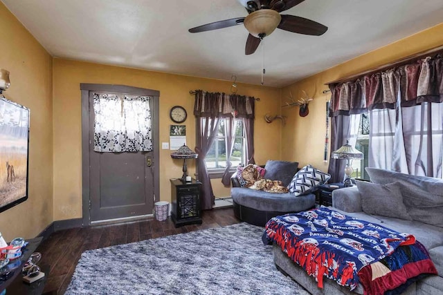 1007 Elkhorn St, Belle Fourche, SD 57717 - living area with wood finished floors, a ceiling fan, baseboards, and a baseboard radiator