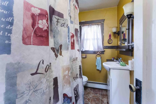 1007 Elkhorn St, Belle Fourche, SD 57717 - bathroom featuring baseboard heating, toilet, and vanity