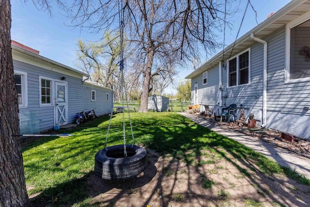 1007 Elkhorn St, Belle Fourche, SD 57717 - view of green lawn featuring an outbuilding and a storage shed