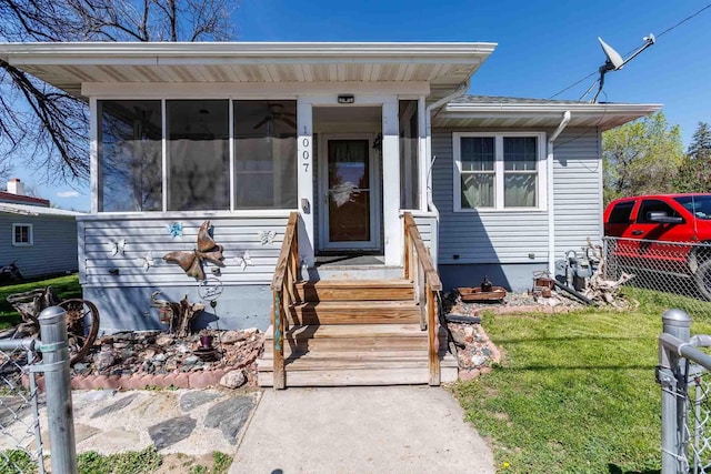 1007 Elkhorn St, Belle Fourche, SD 57717 - view of front facade featuring a sunroom