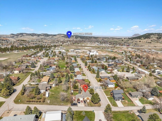 2921 1st Ave, Sturgis, SD 57785 - aerial view of property and surrounding area featuring nearby suburban area and a mountainous background