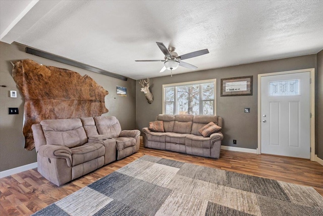 2921 1st Ave, Sturgis, SD 57785 - living area with wood finished floors, ceiling fan, baseboards, and a textured ceiling