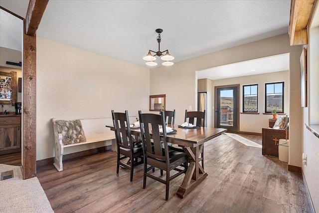 10226 Buena Vista Ln, Belle Fourche, SD 57717 - dining room featuring wood finished floors, baseboards, and a chandelier