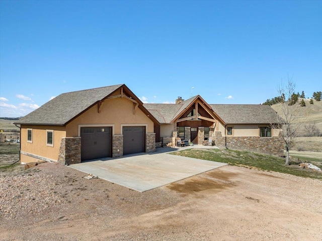 10226 Buena Vista Ln, Belle Fourche, SD 57717 - view of front facade with driveway, stucco siding, and stone siding