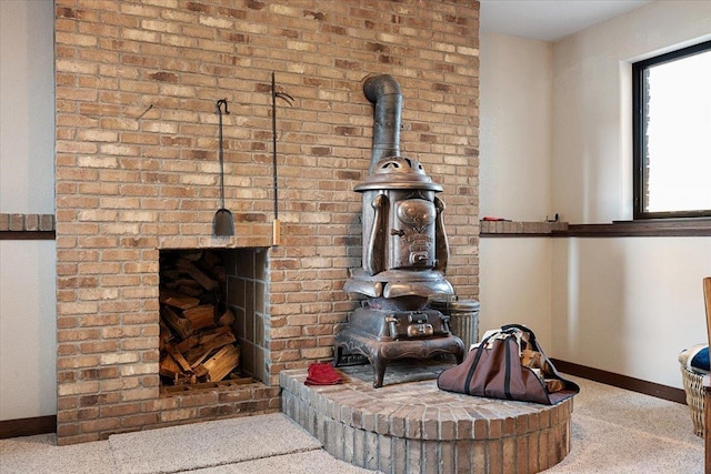 10226 Buena Vista Ln, Belle Fourche, SD 57717 - detailed view of baseboards, a wood stove, carpet, and a fireplace