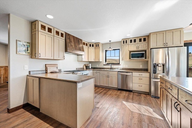 10226 Buena Vista Ln, Belle Fourche, SD 57717 - kitchen with custom range hood, appliances with stainless steel finishes, wood finished floors, glass insert cabinets, and recessed lighting