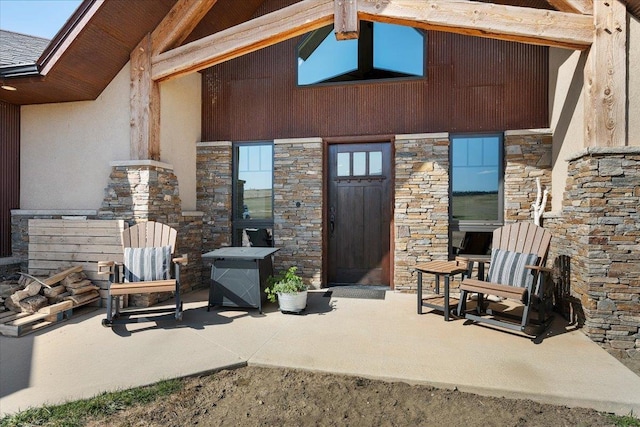 10226 Buena Vista Ln, Belle Fourche, SD 57717 - doorway to property with stone siding, a patio, and stucco siding