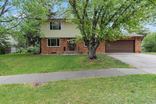 3520 Arizona St, Rapid City, SD 57701 - colonial house with driveway, an attached garage, a front lawn, and brick siding