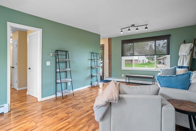 3520 Arizona St, Rapid City, SD 57701 - living room featuring light wood finished floors, baseboard heating, and baseboards