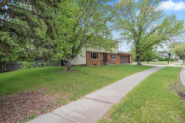 3520 Arizona St, Rapid City, SD 57701 - view of front of house with a garage, brick siding, and driveway