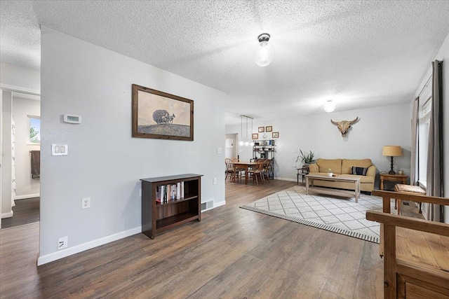 733 Zenith St, Belle Fourche, SD 57717 - living area with wood finished floors, a textured ceiling, and baseboards