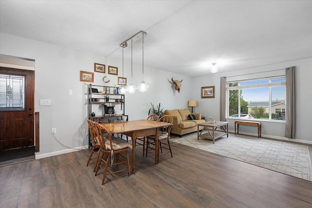 733 Zenith St, Belle Fourche, SD 57717 - dining room featuring wood finished floors, baseboards, and a textured ceiling