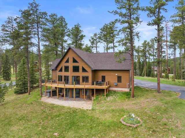 11132 Bogey Cir, Lead, SD 57754 - back of property with a lawn, a wooden deck, roof with shingles, and driveway