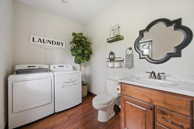 11132 Bogey Cir, Lead, SD 57754 - bathroom featuring separate washer and dryer, hardwood / wood-style floors, toilet, and vanity