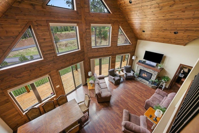 11132 Bogey Cir, Lead, SD 57754 - living room featuring high vaulted ceiling, plenty of natural light, wood ceiling, a stone fireplace, and wood-type flooring